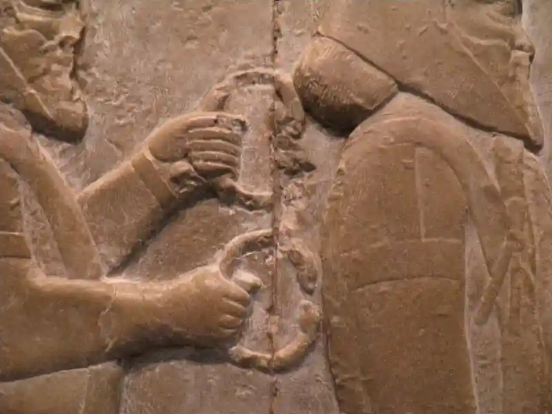 Traveling people, one holding a double headed animal bracelet Traveling people, one holding a double headed animal bracelet